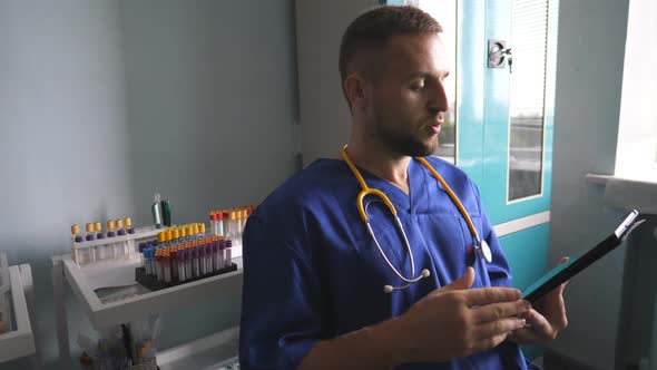 Young Doctor Consult Patient Using Tablet