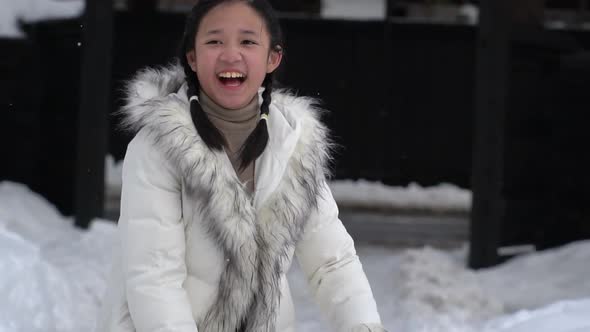 Cute Asian Girl Enjoy With Snow On Winter Day