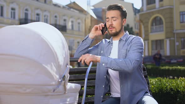 Inexperienced Father Talking Phone Swinging Crying Baby Stroller, Asking Advice