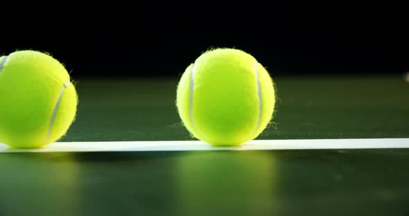 Tennis balls arranged on white line 4k