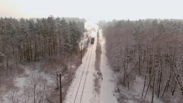 Aerial of an Antique Restored Steam Locomotive Blowing Smoke Steam Traveling