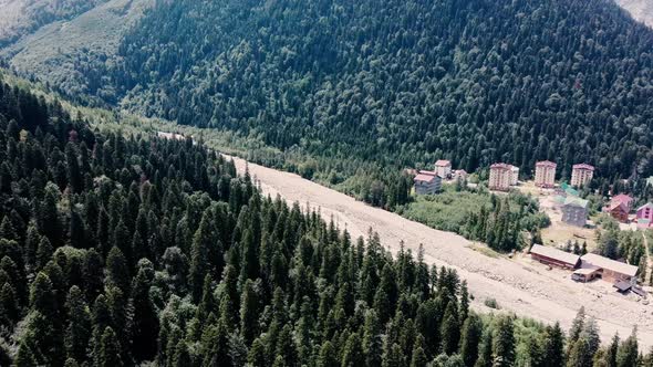 Aerial View of Mountain Forests Between River on Sunny Weather