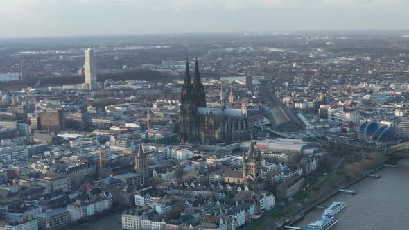 AERIAL: Wide Shot of Cologne Germany From the Air with Majestic Cathedral on Sunny Day 