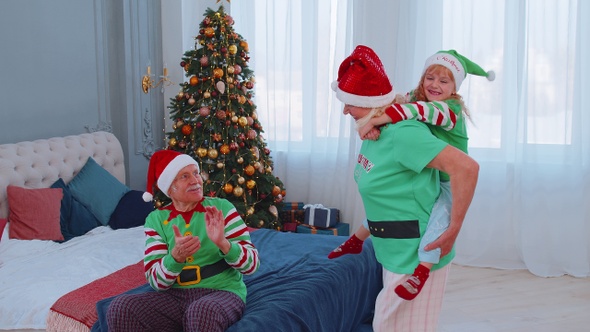 Grandmother Carrying Small Girl Toddler Kid Playing Piggyback Ride Game at Home Christmas Bedroom