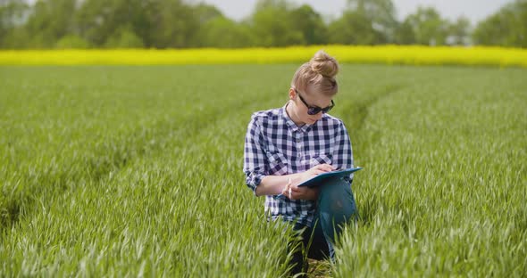 Agriculture Female Farmer Examining Young Wheat Field