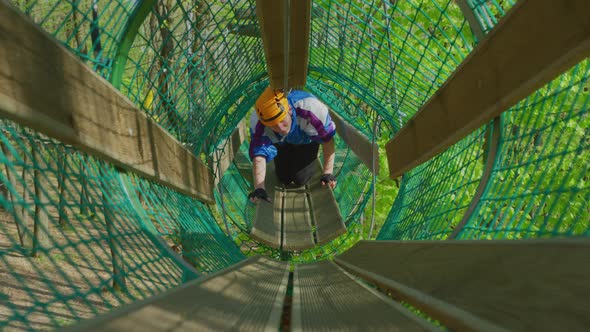 Man in a suspended net tunnel