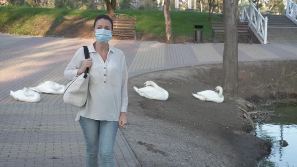 Woman in mask by the birds. 