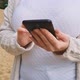 Woman Uses Modern Smartphone in Nature - VideoHive Item for Sale