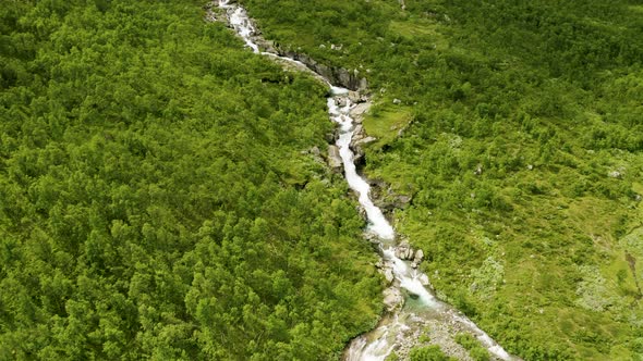 Water Flowing On The Narrow River Through The Lush Hydalen Valley, A Hidden Gem In Hemsedal, Norway