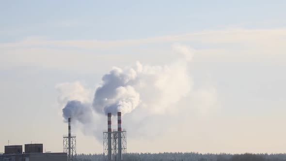 Timelapse. Smoke is coming from the boiler room chimney. Warming.