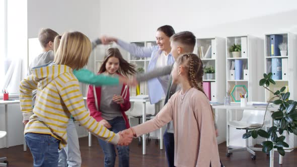 Teenagers Playing Human Arch with Counselor