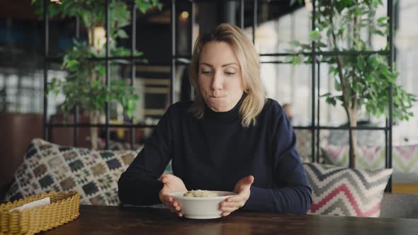 Funny Young Woman Rejoices in a Delicious Salad