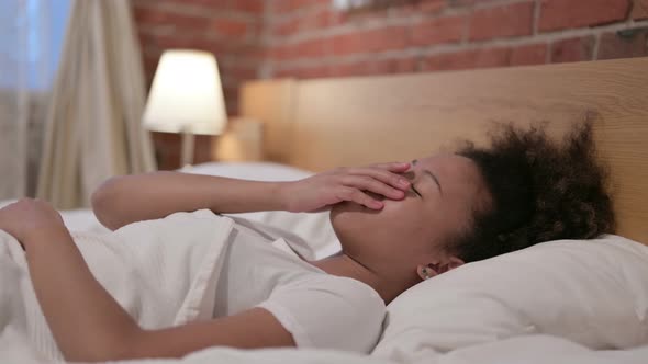 African Woman Crying While Sleeping in Bed