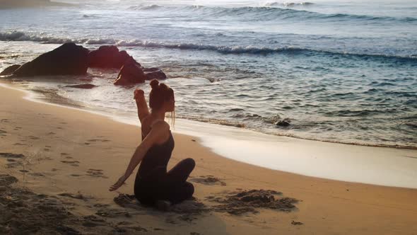 Exciting Lady in Black Tracksuit in Yoga Pose Near Ocean