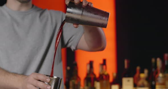 Bartender Superfuses Mixed Drink From One Part of Shaker to Another in Slow Motion Barman Mixes