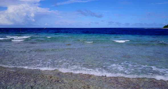 Daytime overhead copy space shot of a summer white paradise sand beach and aqua turquoise water back