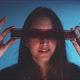Woman holding film strip, covering her eyes - VideoHive Item for Sale