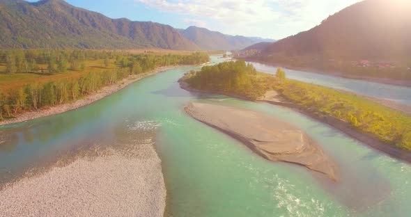 Low Altitude Flight Over Fresh Fast Mountain River with Rocks at Sunny Summer Morning