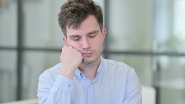 Portrait of Sleepy Young Man Taking Nap