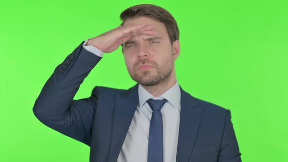Young Businessman Looking Around, Searching Green Screen