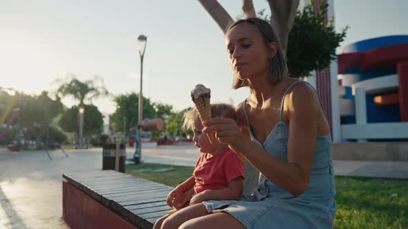 Close Up Shot of a Young Loving Family Clinking Ice Cream Cones and the Child Keeps on Eating His