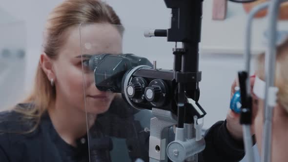Optometrist Giving Slit Lamp Examination of the Eyes in Ophthalmology Clinic