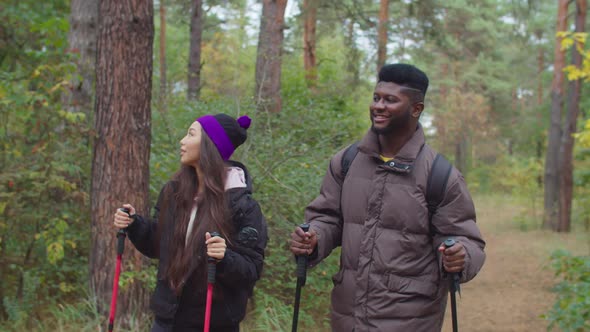 Multiethnic Hikers Couple Backpacking in Nature