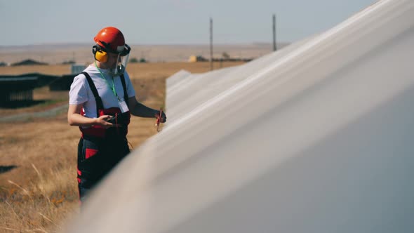 Serviceman Is Measuring Electricity in Solar Panels