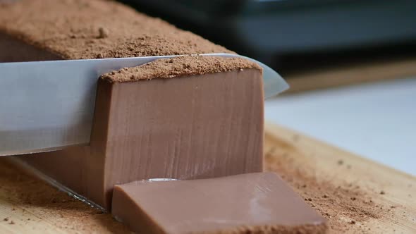 Close Up Of The Knife Is Cutting Chocolate Pudding