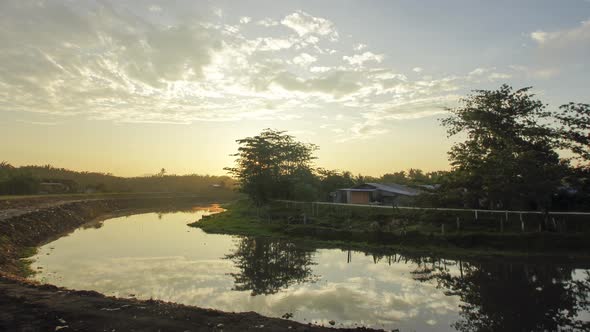 Timelapse sunrise at river near Malay kampung