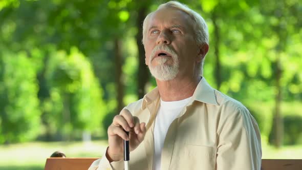 Mature Man With Visual Impairment Trying to See Nature, Rehabilitation Period