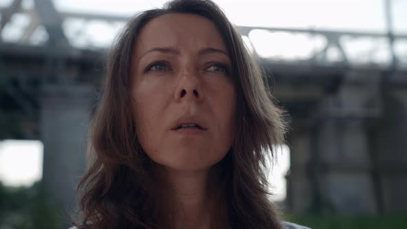 a Female Portrait Against the Background of a Railway Bridge is Out of Focus