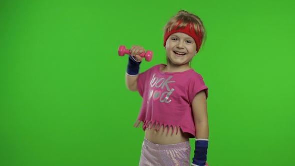 Caucasian Girl in Sportswear Making Exercises with Dumbbells. Workout for Kids. Athletic Child