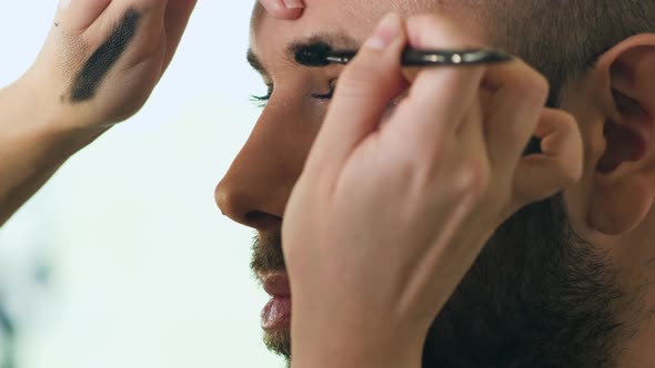 Makeup Artist Does Makeup On Face Of Bearded Man