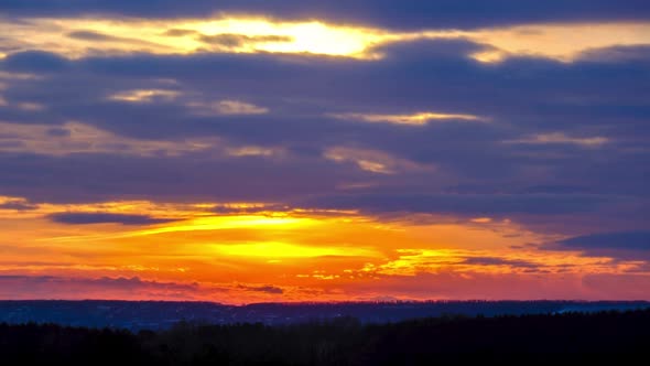 Dramatic Sunset in the Sky Through Orange Layered Cumulus Clouds Timelapse