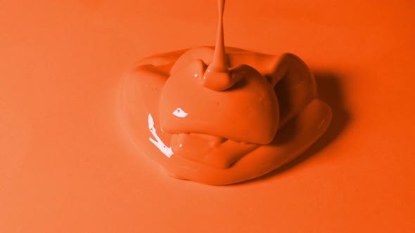 Orange Paint Poured Onto Orange Surface