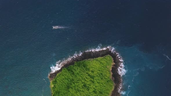 Aerial Amazing View Over the Blue Ocean with Green Islet and Boat.