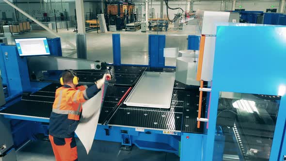 Laborer Working with Industrial Equipment