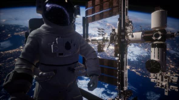 International Space Station and Astronaut in Outer Space Over the Planet Earth alt