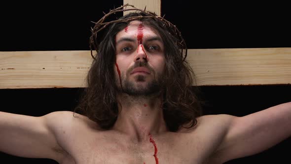 Suffering Jesus With Blood on Body Looking Camera, Religious Forgiving, Kindness