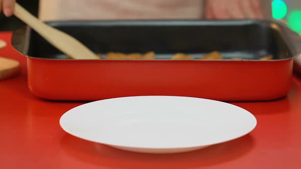 Woman Putting Gingerbread Cookies on Plate, Sweet Christmas Dessert, Closeup