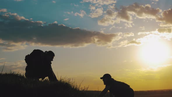 Climber Helping Teammate Climb, the Man with the Backpack Reached Out a Helping Hand To His Friend alt