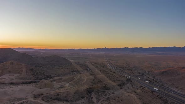 Traffic on Highway in Desert at Sunset. Arizona, USA. Aerial View