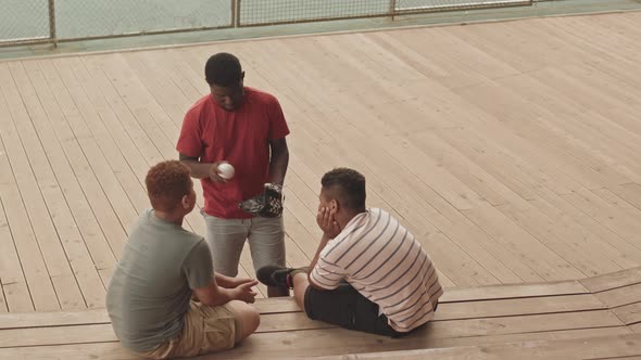Male Coach Teaching Baseball Outdoors