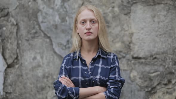 Portrait of Unhappy Woman in Blue Plaid Shirt Looking To Camera. Crop View of Female Person with
