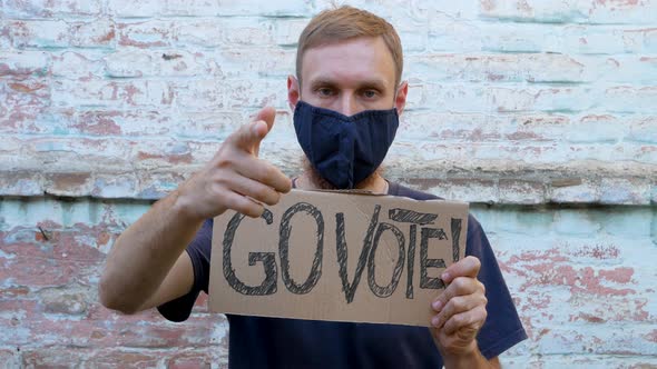 Man shows cardboard Go Vote sign Make the political choice Use your voice Presidential elections 4K