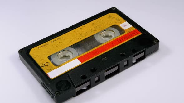 Audio Cassette Rotates on White Background