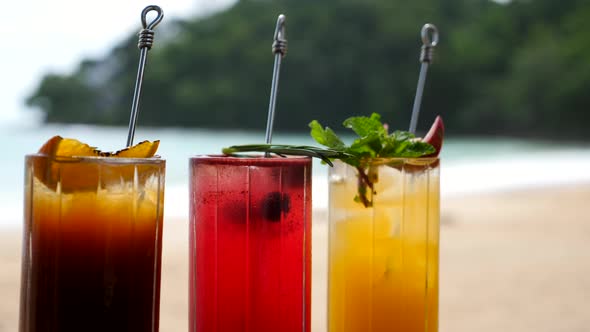 Bright Healthy Berries Cocktails on Table on Beach with Blue Sea on Background