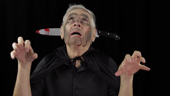Elderly Man with Knife in Head. Halloween Makeup and Costume. Blood on His Face