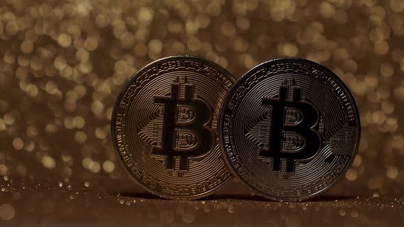 Close Up on gold background with bokeh. Bitcoin BTC coin. New virtual currency.